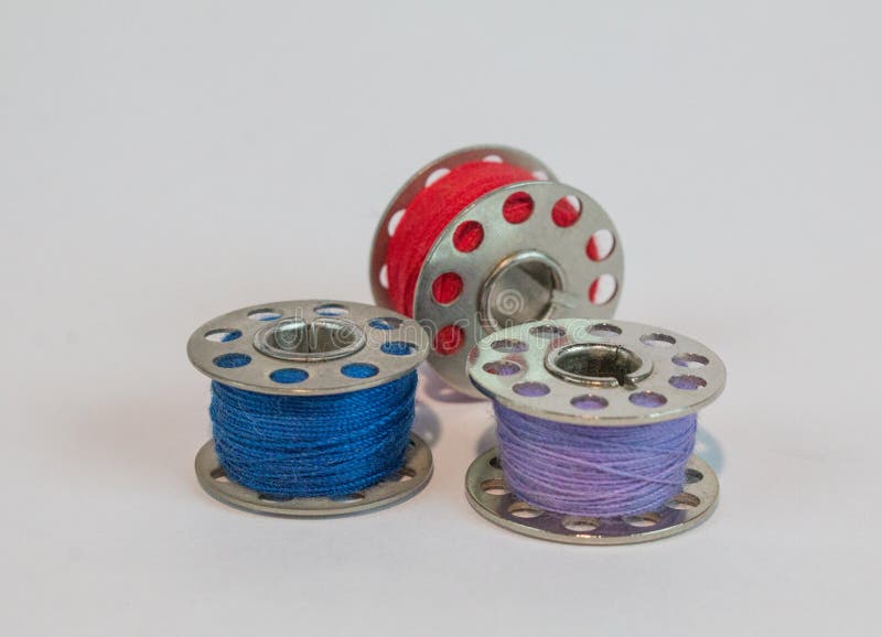 Three Sewing Machine Bobbins with Colorful Thread Stock Image Image