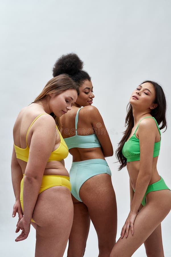 Three Joyful Young Women with Different Body Shapes Wearing