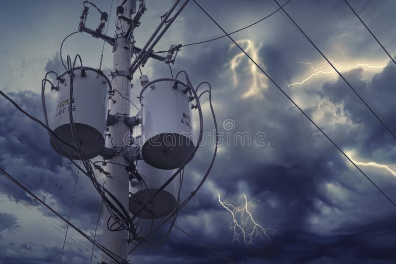 Three single-phase pole-mounted distribution transformers. During an overcast sky or before a storm