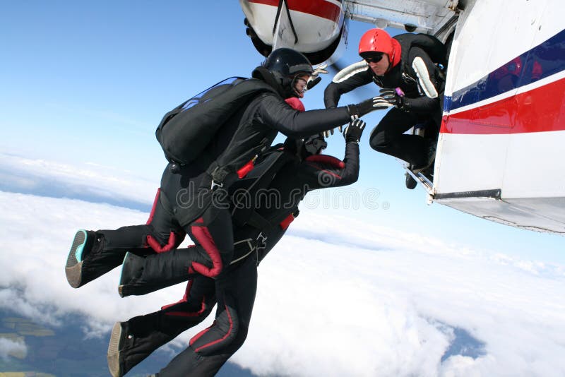 Three skydivers jump from a plane royalty free stock image