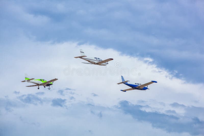 Three Small Aircraft Flying In The Sky Against A Background Of Clouds Stock Photo Image of