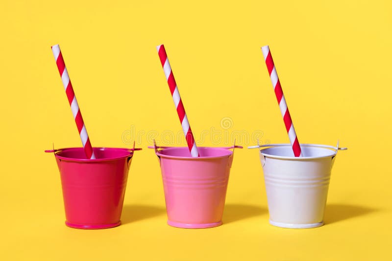 https://thumbs.dreamstime.com/b/three-small-buckets-yellow-background-striped-straws-red-pink-white-concept-immense-thirst-need-water-212105830.jpg
