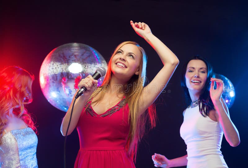 Three Smiling Women Dancing and Singing Karaoke Stock Photo - Image of ...