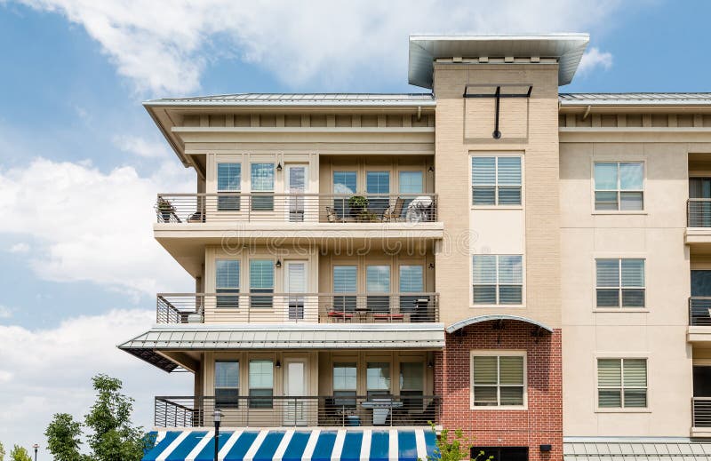 Three Story Condo Over Blue and White Awning