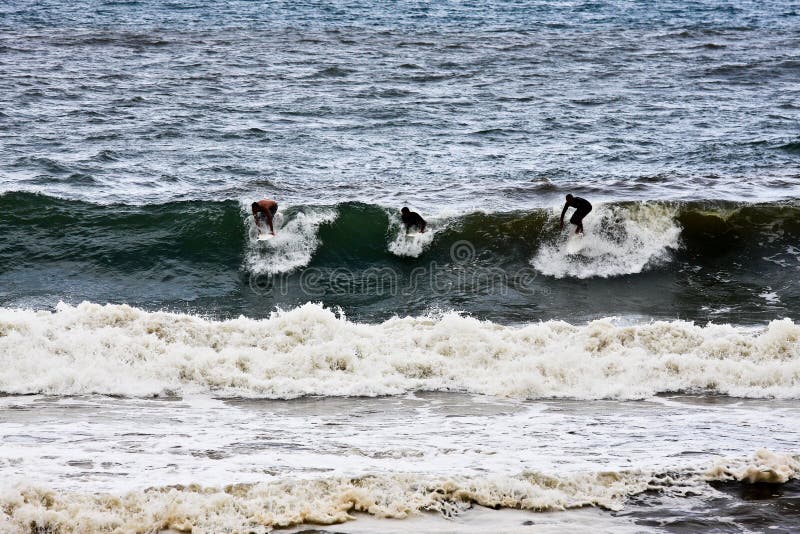 Three surfers
