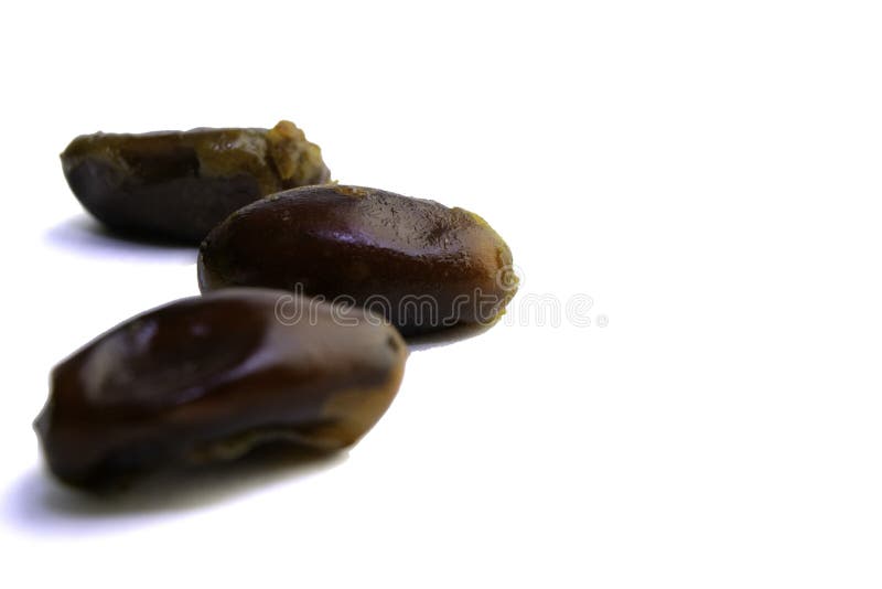 Sweet Dried Dates Laid Out in Several Rows on a White Background Stock
