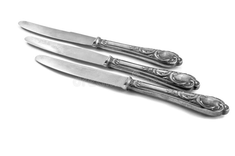 Three table knifes on white background