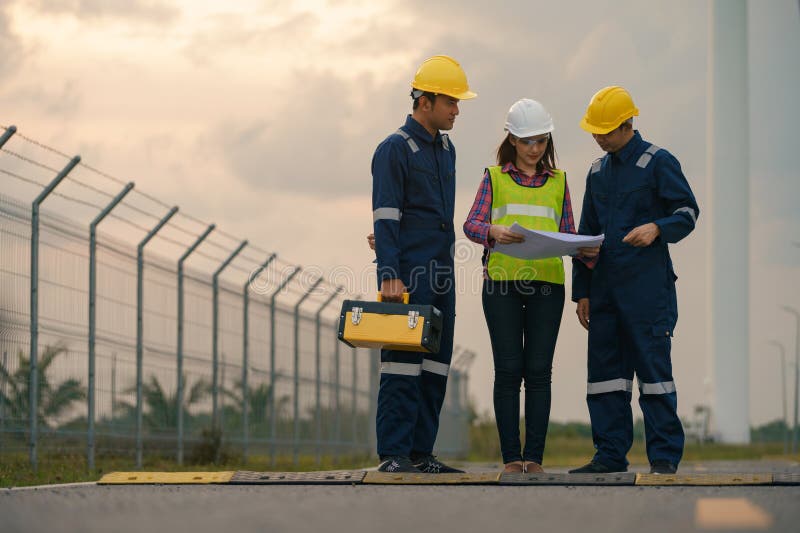 Three Technician Engineer in Uniform with Standing and Checking Wind