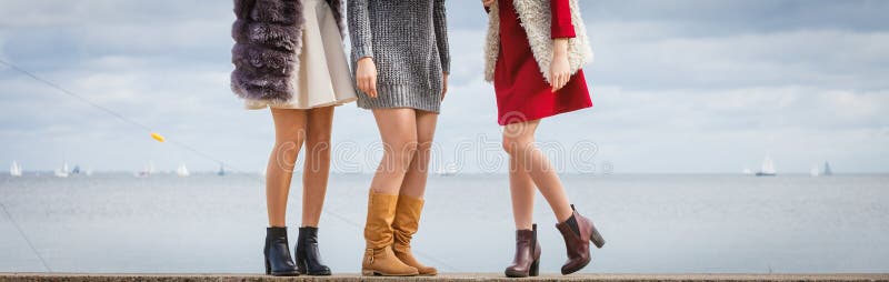 Three unrecognizable fashionable women wearing stylish shoes outdoor. Boots perfect for autumn and winter. Three unrecognizable fashionable women wearing stylish shoes outdoor. Boots perfect for autumn and winter