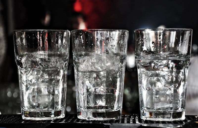 Three Vodka Glasses on the Bar with Lots of Ice Stock Image Image of