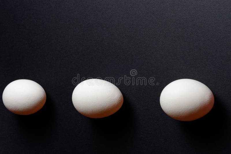 Three White Eggs on a Black Background, Dietary and Healthy Food Rich