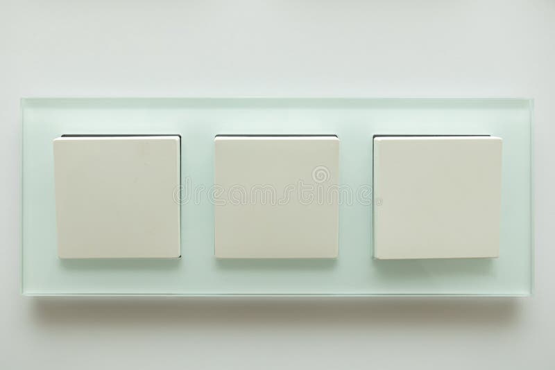 Three White Electric Switches on a Wall Stock Photo Image of design