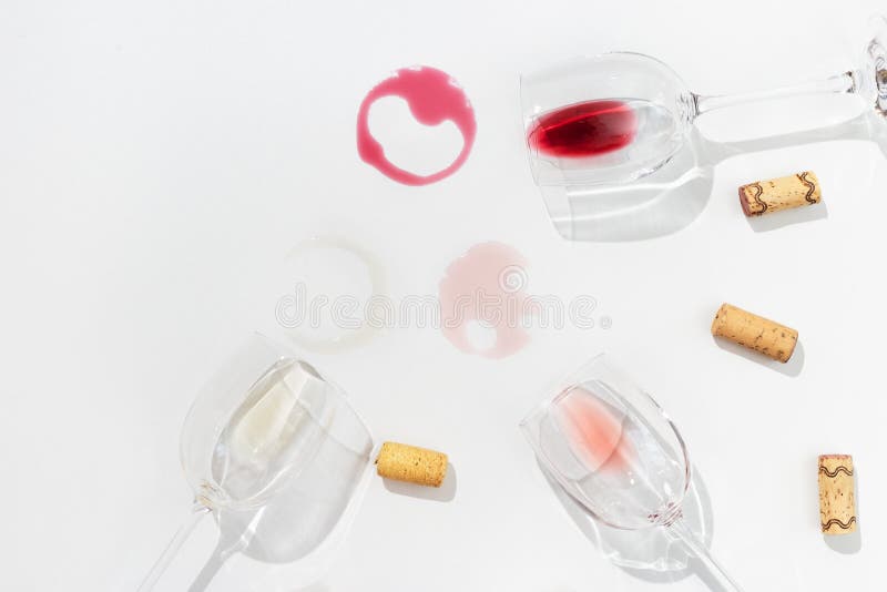 Three wine glasses top view. Red, rose and white wine on light background with dark shadow. Three wine glasses top view. Red, rose and white wine on light background with dark shadow