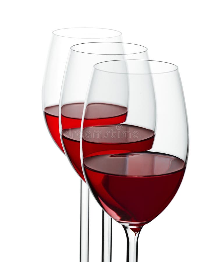 Three wineglases with red wine