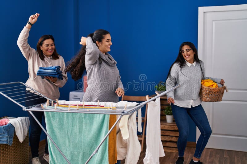 Three Woman Hanging Clothes on Clothesline and Dancing at Laundry Room