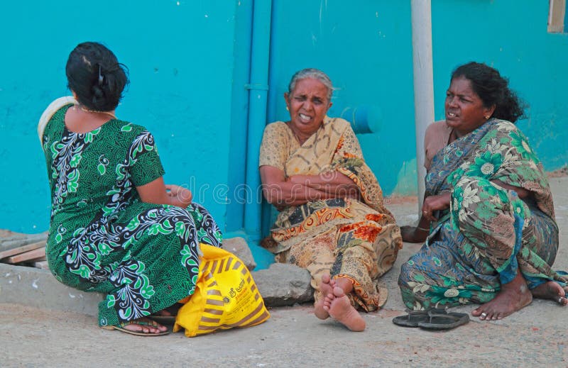 Three women are sitting outdoor in Kanyakumari, India stock photo Three women are sitting outdoor in Kanyakumari, India stock photo