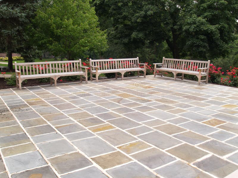 Three wood benches by a patio