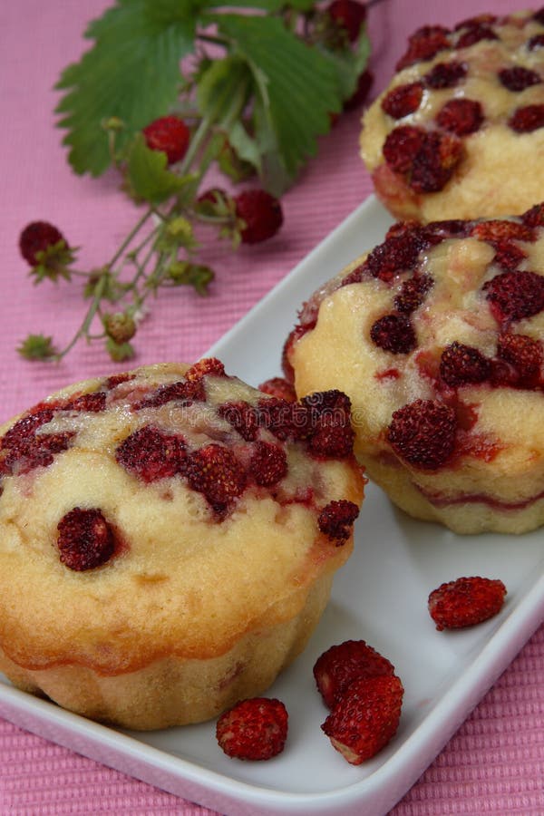 Three wood strawberry muffins on plate royalty free stock photography Three wood strawberry muffins on plate royalty free stock photography
