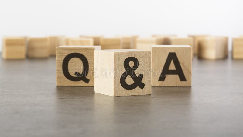 Three wooden blocks with letters Q and A with focus to the single cube in the foreground in a conceptual image on grey stock images