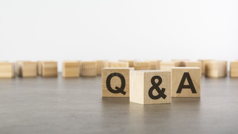 Three wooden blocks with letters Q and A with focus to the single cube in the foreground in a conceptual image on grey stock image
