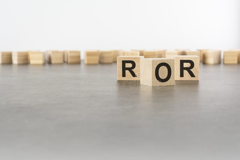 Three wooden blocks with letters ROR with focus to the single cube in the foreground in a conceptual image on grey royalty free stock photography