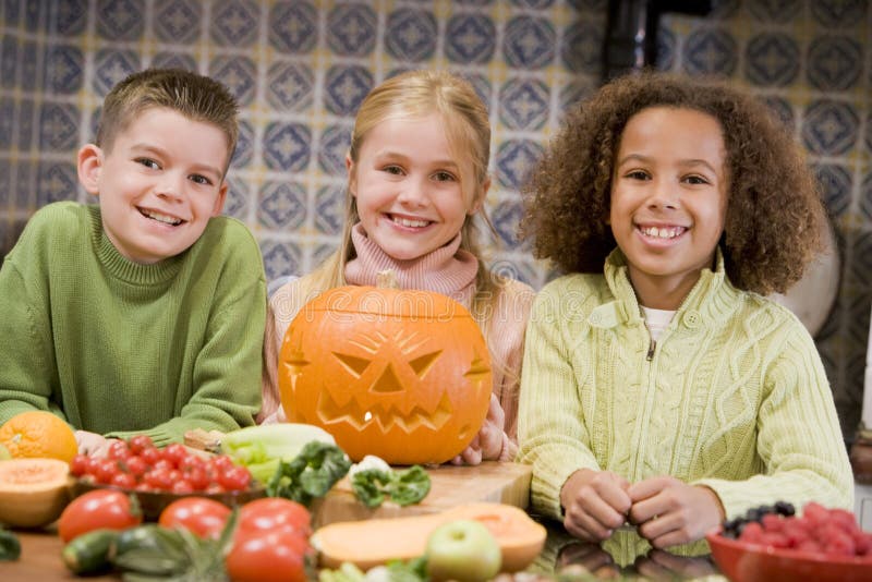 Three young friends on Halloween with pumpkin royalty free stock photography Three young friends on Halloween with pumpkin royalty free stock photography