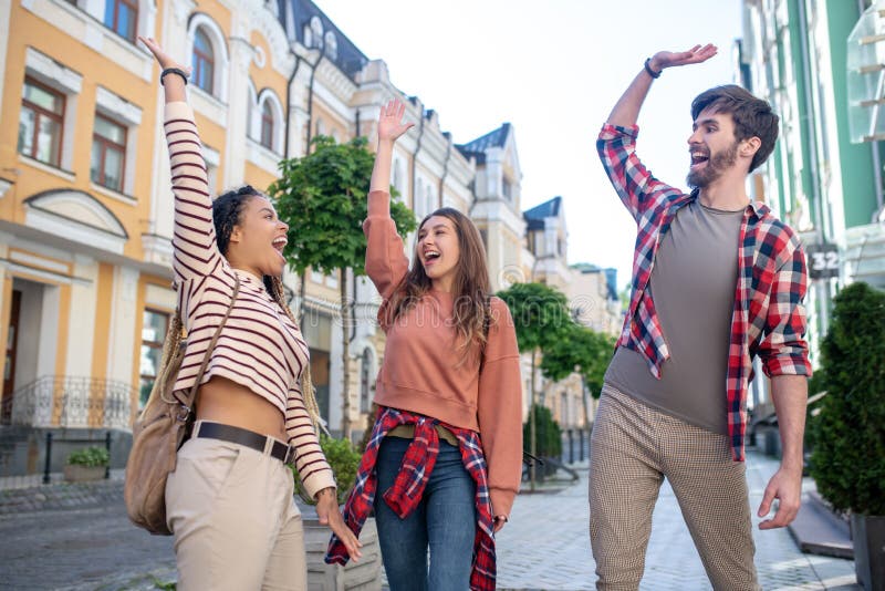 Three young friends having fun in the city.