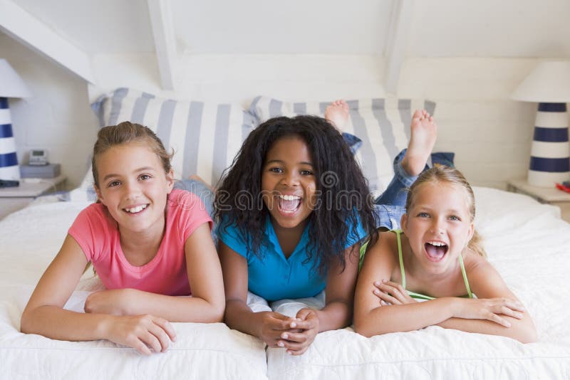 Three Young Friends Lying Down Next To Each Other stock photography