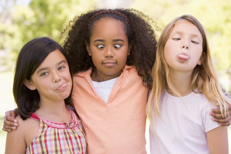 Three young girl friends outdoors making funny faces. Three young girl friends outdoors making funny faces