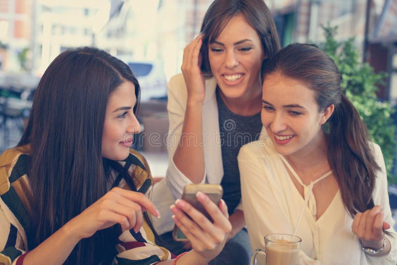 Three young women have fun conversation in cafe. royalty free stock photos Three young women have fun conversation in cafe. royalty free stock photos