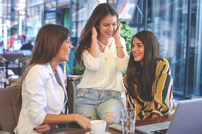 Three young women having conversation in cafe. Girls having break coffee. royalty free stock photography Three young women having conversation in cafe. Girls having break coffee. royalty free stock photography