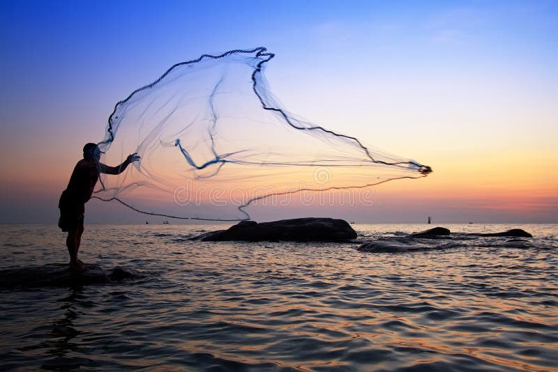 Throwing fishing net during sunrise, Thailand