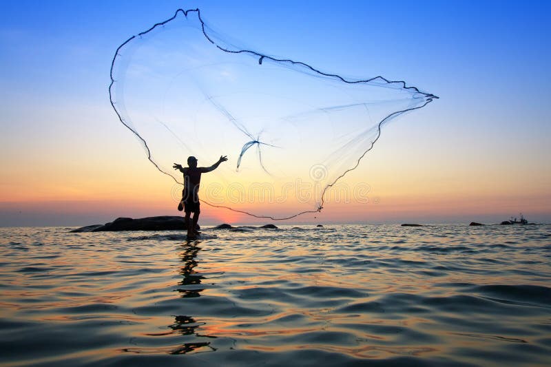 Fisherman with a wicker basket and fishing net goes to the sea. Picturesque  landscape of Thailand coast Stock Photo