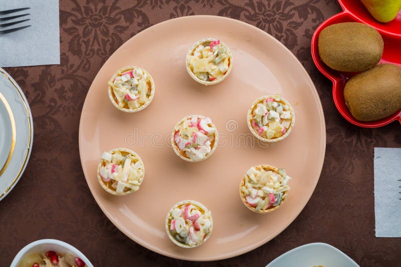 Throwing Forks on the Table Set with Salad in Tartlets, Fruit Snacks