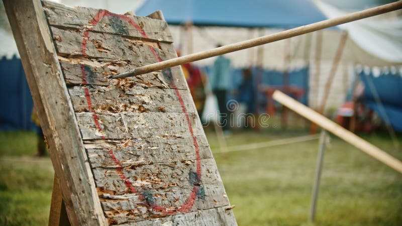 Throwing a spear in the wooden target - training outdoors