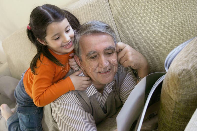 Grandfather and little girl reading a book. Grandfather and little girl reading a book