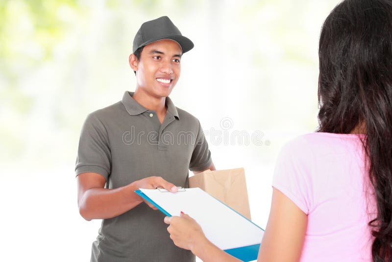 Woman receiving a package at home from a delivery guy. Woman receiving a package at home from a delivery guy