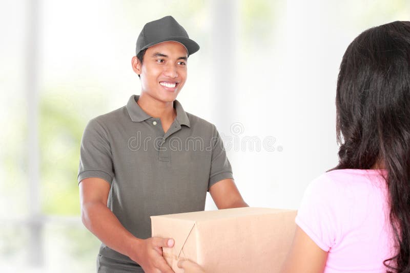 Woman receiving a package at home from a delivery guy. Woman receiving a package at home from a delivery guy