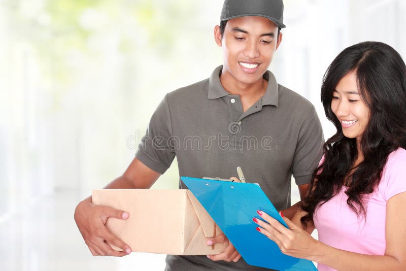 Woman receiving a package at home from a delivery guy. Woman receiving a package at home from a delivery guy