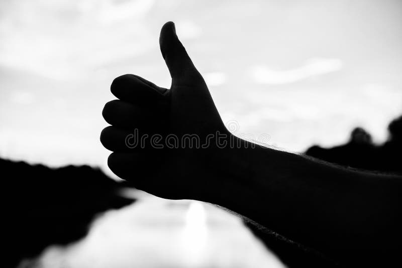 Thumbs up gesture sign of best choice approve and accept. Top places to visit in evening. Silhouette thumb up gesture in stock images Thumbs up gesture sign of best choice approve and accept. Top places to visit in evening. Silhouette thumb up gesture in stock images