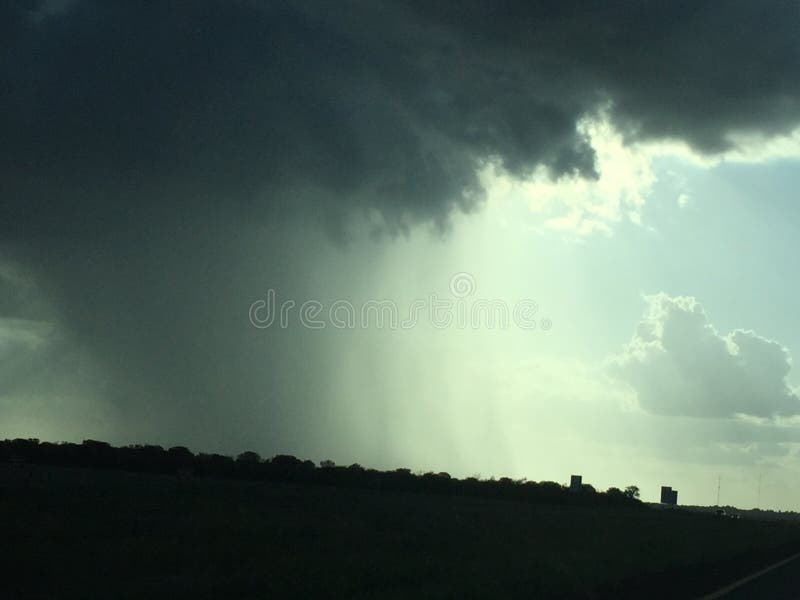 Rainstorm in the Distance, Behind Three Sisters Rock Formation in