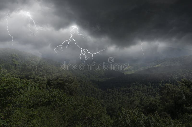 Thunder and lightning storm over deep valley and mountains royalty free stock photos