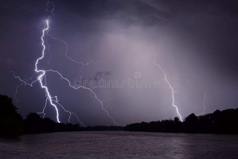 Thunder, lightnings and rain during storm over river and forest royalty free stock photography Thunder, lightnings and rain during storm over river and forest royalty free stock photography