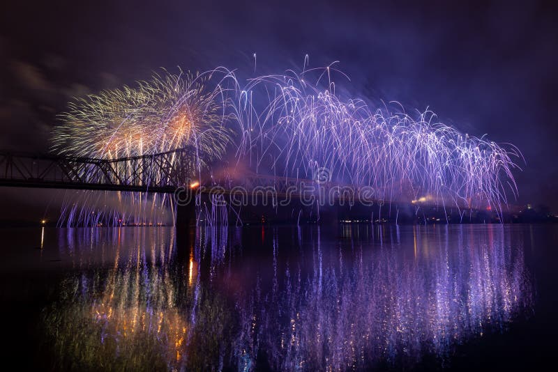 Louisville, Kentucky, USA - April 13, 2019: , Fire works display on the George Rogers Clark Memorial Bridge and a river barge at the Ohio River. Louisville, Kentucky, USA - April 13, 2019: , Fire works display on the George Rogers Clark Memorial Bridge and a river barge at the Ohio River