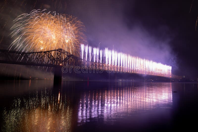 Louisville, Kentucky, USA - April 13, 2019: , Fire works display on the George Rogers Clark Memorial Bridge and a river barge at the Ohio River. Louisville, Kentucky, USA - April 13, 2019: , Fire works display on the George Rogers Clark Memorial Bridge and a river barge at the Ohio River