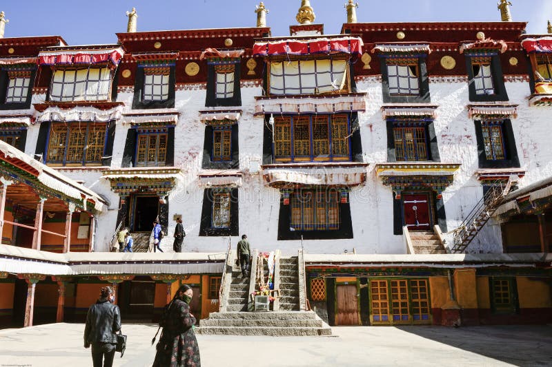 Tibetan Bhuddists wander the courtyard in Drepung Monastery in Lhasa, Tibet. royalty free stock photography Tibetan Bhuddists wander the courtyard in Drepung Monastery in Lhasa, Tibet. royalty free stock photography