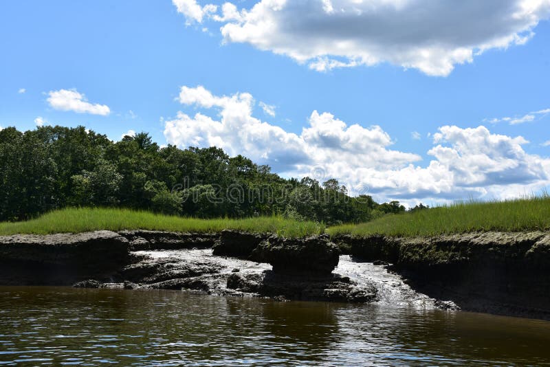 Tidal Flats and Marsh Land Under Cloudy Skies. Pretty marsh land and tidal flats under cloudy skies