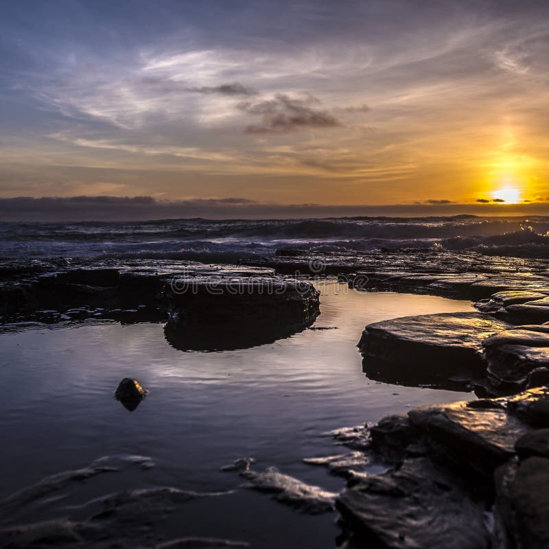 Tide pools with a dramatic sunset in San Diego