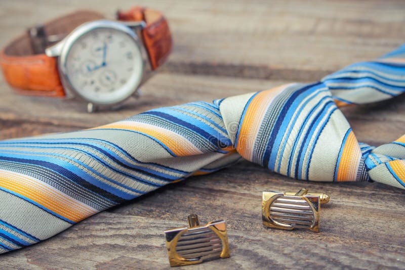 Tie, cufflinks and watches on the old wood background. Button clasp stock images, royalty-free photos and pictures