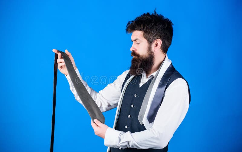 The tie is just the ticket for any menswear outfits. Bearded man choosing neck tie. Brutal hipster holding colorful tie collection. Find yourself a unique tie and mens accessories.